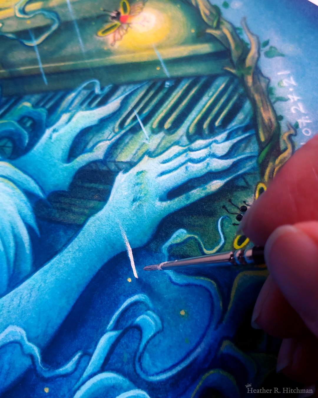 Close up photograph of a watercolor and gouache painting print of “Blue Hair and the Piano” by Heather R. Hitchman. The painting has a moody and rainy atmosphere. The photograph focuses on the faun’s blue hands that are playing the keys on a piano. A firefly can be seen floating above the hands and glowing with a bright golden light. The fingertips of the artist are visible to the bottom right corner of the photograph holding a tiny paintbrush, which is painting silver metallic paint over a raindrop in the painting.