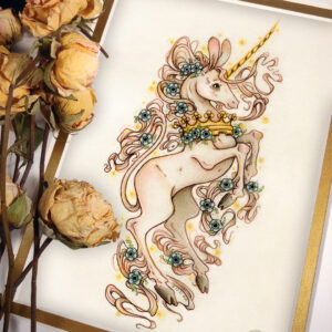 Photograph of a matted print of a colored pencil and graphite drawing of a pinkish white unicorn rearing up in profile, facing to the right. The swift unicorn has long rabbit like ears, an extra long thin golden horn, and a petite build. A golden crown is worn around the unicorn’s neck. Long tendrils of a pinkish white mane swirl around the unicorn’s body, as well as tufts of fur coming from just above the hooves and the unicorn’s chin. Blue anemone flowers are sprinkled throughout the unicorn’s hair and fur tufts. Small orbs of golden light surround the unicorn. The unicorn has dark wide eyes and a smiling expression on its face. The unicorn’s tail resembles a lion’s tail, long and thin with a tuft of long white hair at the end. The mat-board is white on the top layer and gold on the second layer. Yellow roses rest on top of the print to the left. A small gold stamp with the Terratoff icon is at the bottom right corner of the print.