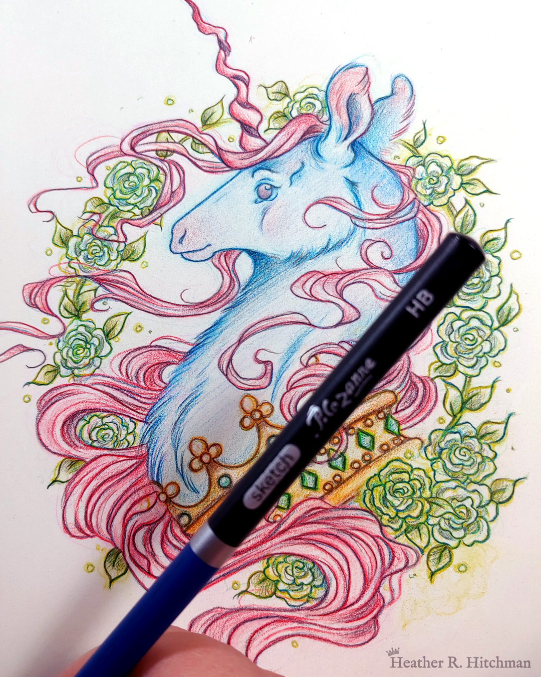 Process photograph of a graphite and colored pencil portrait drawing of a blue and red dark unicorn bust framed in a circular wreath of soft green gardenia flowers. The background inside of the wreath behind the unicorn is sepia with tiny orbs of green light floating around. Outside of the wreath the portrait has a sepia background color. The unicorn lifts his head proudly in profile facing to the left. He has a flowing red mane and chin beard, blue fur, and a long red corkscrew horn in the center of his forehead. The dark unicorn wears a large crown of emerald and ruby jewels around his neck. The artist’s fingertips are visible in the bottom right corner holding a graphite pencil.