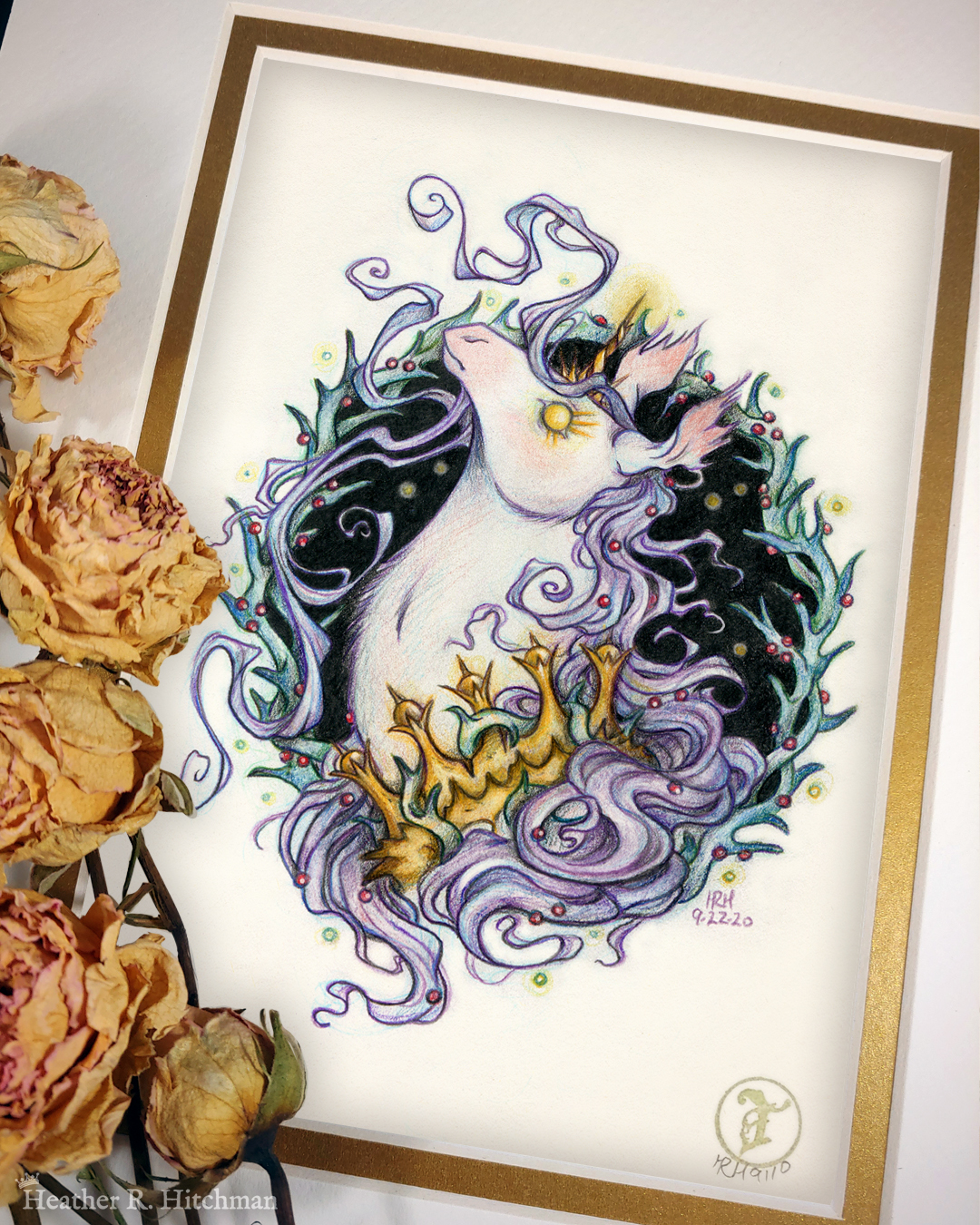 Photograph of a matted print of a graphite and colored pencil portrait drawing of a corrupted rotten unicorn with pinkish white fur and a flowing purple mane, framed in a circular wreath of thorns growing small red berries. The background inside of the wreath behind the unicorn is black with tiny orbs of golden light floating around. Outside of the wreath the portrait has a sepia background color. The unicorn is throwing up her head in profile facing to the left with a stern expression. Her golden eye has long sharp golden lashes, and gazes towards the viewer. She has a short broken golden horn in the center of her forehead. The unicorn wears a thorny golden crown around her neck. The mat-board is white on the top layer and gold on the second layer. Yellow roses rest on top of the print to the left. A small gold stamp with the Terratoff icon is at the bottom right corner of the print.