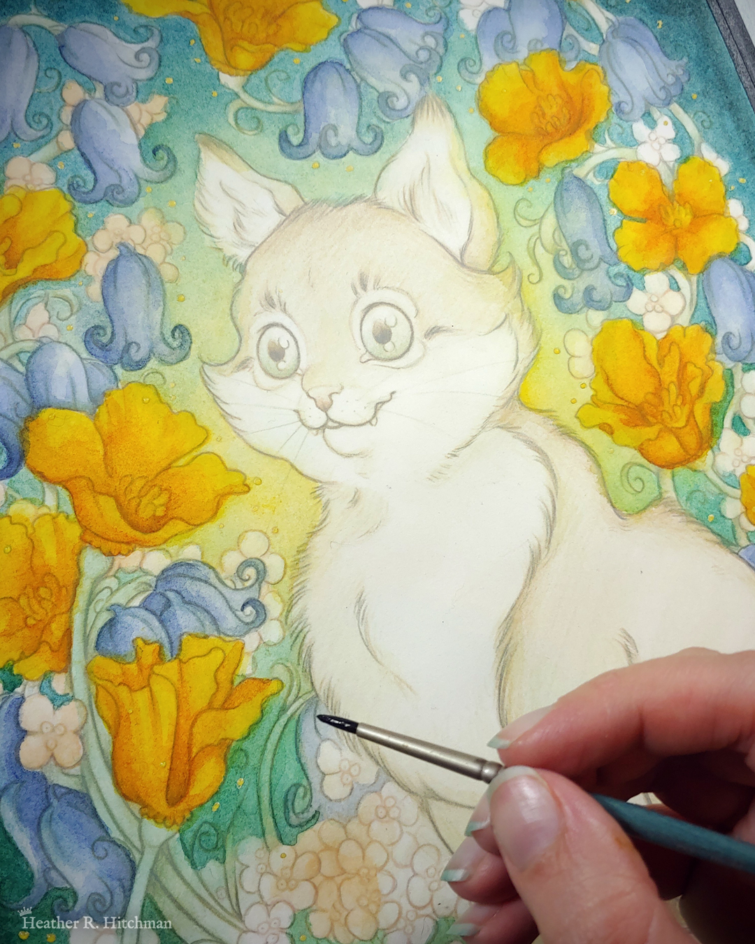 Close up photograph of a watercolor, gouache, and colored pencil portrait painting of an orange cat sitting in a garden. The painting is currently being painted by the artist, who’s hand is in the bottom right of the photograph holding a paintbrush. So far the painting is composed of loose line art and washes of watercolor. The photograph focuses on the cat’s face. The cat sits upright at a ¾ angle on the grass, facing to the left with a wide eyed happy expression on his face. His fur is tinted with a light wash of golden orange. An archway of bluebells, yellow California poppies, and small white flowers surround the cat in an enchanted garden scene. The background is dark teal green with a sunburst of yellow light coming from behind the cat.
